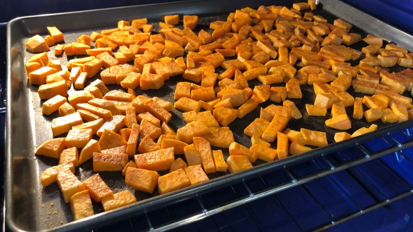 Sweet potatoes on cookie sheet in oven