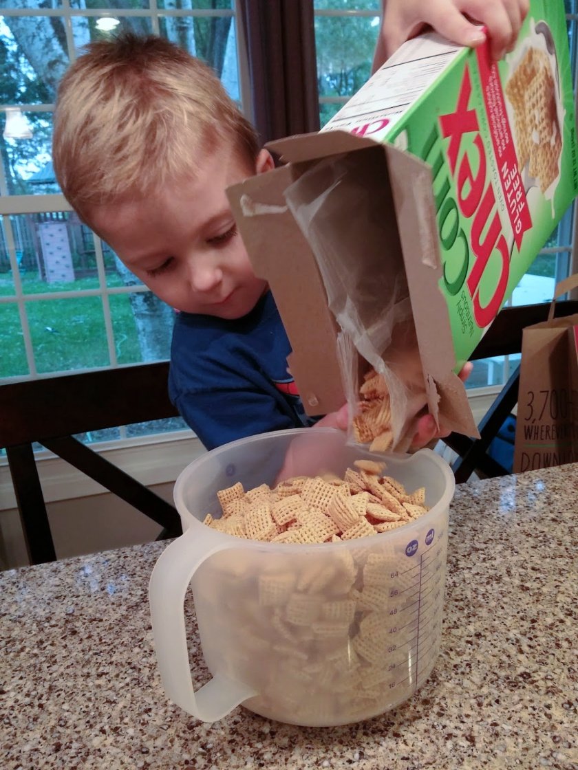 Pouring cereal for Puppy Chow